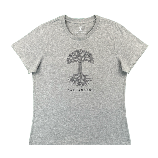 The Women's Oaklandish Logo Tee by Oaklandish is a classic fit, athletic grey shirt made from 100% cotton. It features a black line art tree with roots and “OAKLANDISH” in bold uppercase centered on the chest.
