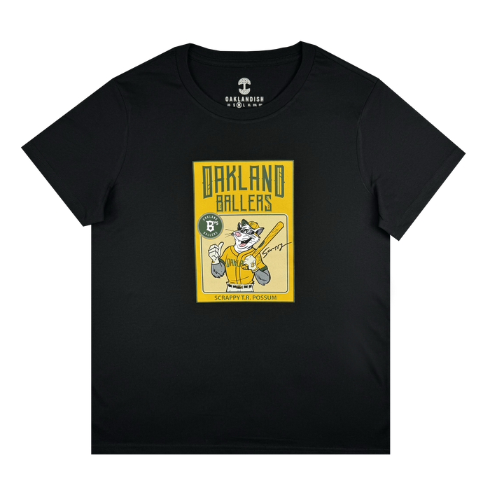 Women’s Scrappy Rookie Card Tee by Other: Black T-shirt showcasing a yellow graphic of cartoon possum Scrappy the Rally Possum holding a baseball bat, wearing sunglasses and a cap—an homage to the Oakland Ballers mascot. Bold “OAKLAND BALLERS” lettering appears above with “SCRAPPY THE POSSUM” below. Brand label at the neck reads “Other”.