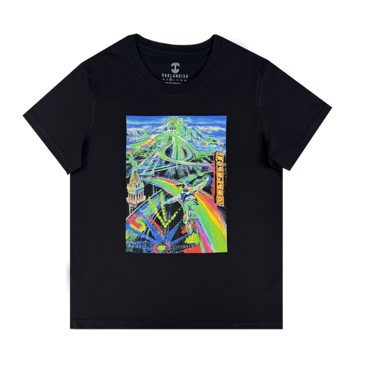 The Women’s Yay Area Tee by Other is a black cotton shirt featuring vibrant, neon-painted Oakland cityscape art with highways, bridges, and the iconic “Oakland” sign in bold yellow lettering. The dynamic urban landmarks stand out in a surreal artistic style against the dark fabric.