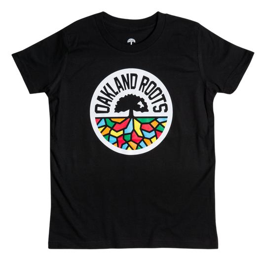 Youth Oakland Roots SC Classic Tee in black, featuring a central circular logo with the words "OAKLAND ROOTS." The logo, inspired by Oaklandish artistry, showcases an abstract tree with roots extending into a vibrant mosaic pattern in red, yellow, blue, and green. Ideal for fans of Oakland Roots Sports Club.