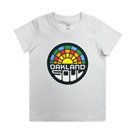 The Youth Oakland Soul Logo Tee features a striking white finish and a vibrant circular graphic on the front. The design showcases a rainbow with a yellow sun at its center, accompanied by the bold text "OAKLAND SOUL" in capital letters below, celebrating women's soccer and Oakland Soul's participation in the USL W-League.