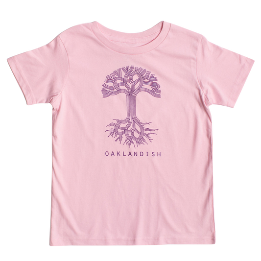 The Youth Oaklandish Classic Logo Tee by Oaklandish features a pink base adorned with a stylized purple tree graphic on the chest. The tree showcases intricate, branching roots and limbs that mimic circuit board patterns. Below the tree, "OAKLANDISH" is printed in bold purple capital letters. Crafted from 100% cotton, it ensures ultimate comfort.