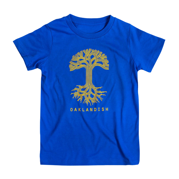 The Youth Oaklandish Classic Logo Tee by Oaklandish is a royal blue youth T-shirt made from 100% cotton. It features a stylized yellow tree design with intricate, symmetrical branches and roots extending from the center. Below the tree, the word "OAKLANDISH" is printed in bold capital letters.
