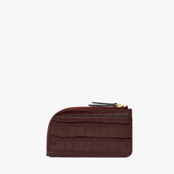 Back panel of STOW London's Zip Wallet in Burgundy Embossed Croc leather on a light grey background featuring a fine gold embossed logo and YKK Natulon zipper